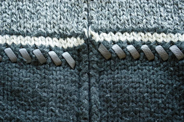 Bakgrund av ull sticka tröja läder stitch — Stockfoto