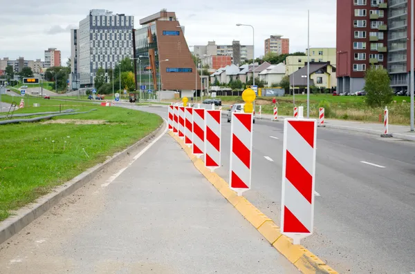 Varovné signály na silnici konstrukce auta domy město — Stock fotografie