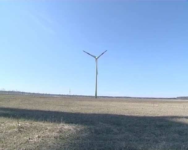 Interesting rotating windmill shadow on forest. — Stock Video