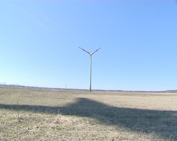 Interesting rotating windmill shadow on forest. — Stock Video