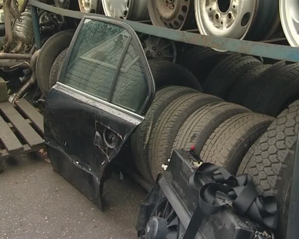 Wheels tires and body parts. automobile parts in dump. — Stock Video