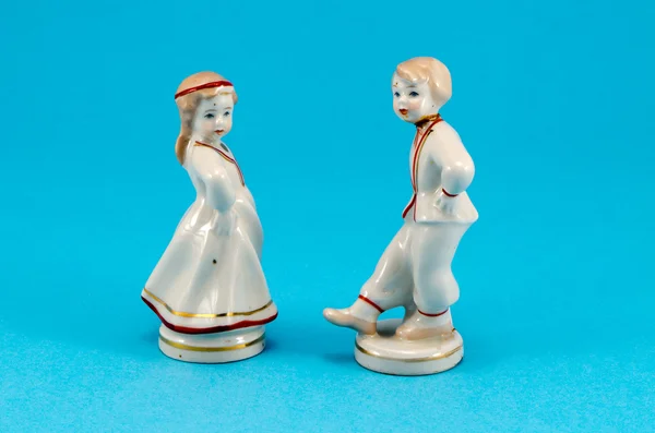 Two ceramic toy decor dancers boy girl on blue — Stock Photo, Image