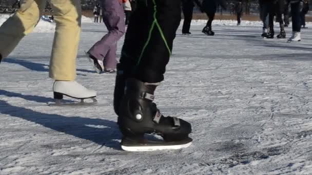 Legs skate slide on frozen lake ice in cold winter day — Stock Video