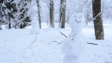 Çift kardan adam stand ağaçlar kapalı kar kış park yürüyüş