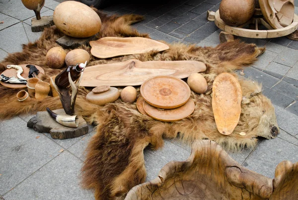 Decorative trays bowls cups of wood on bear fur — Stock Photo, Image