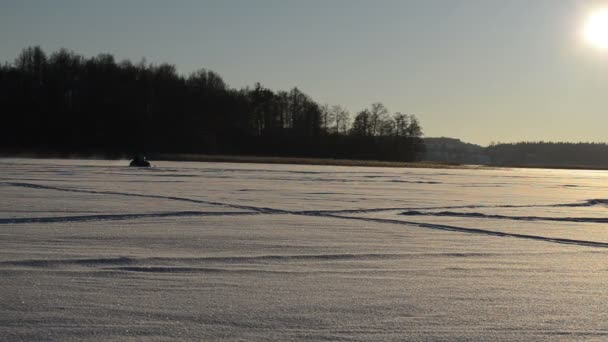 Moto de nieve transporte cruz lago nieve invierno deporte extremo puesta de sol — Vídeo de stock