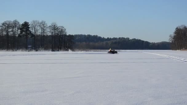 Man ride snowmobile transport lake ice winter extreme sport — Stock Video