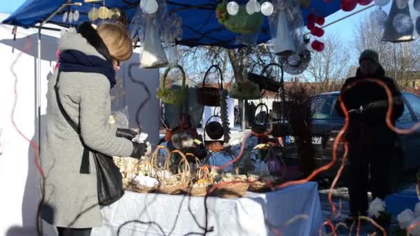 Woman handmade angels decorations hang market fair tent — Stock Video