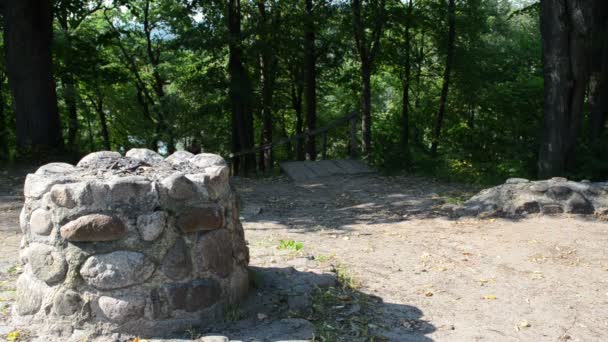 Young woman climb stairs hill pass old stone pagan altar — Stock Video