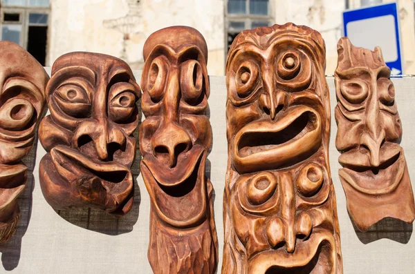 Wooden carved funny masks spring fair rural crafts — Stock Photo, Image