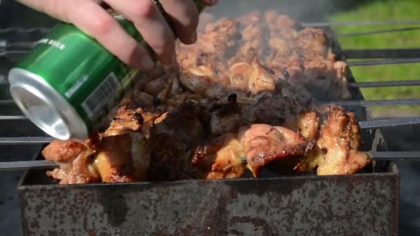 Beer pour on baking meat — Stock Video