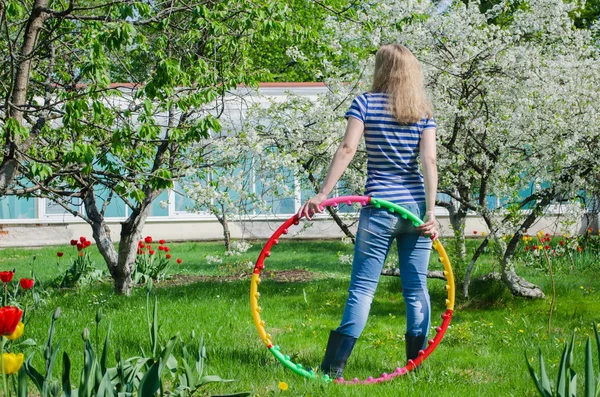 Woman hold colorful hula hoop nature background — Stock Photo, Image