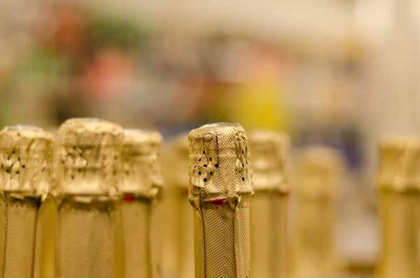 Close up champagne bottle cork wrapped shiny paper — Stock Photo, Image