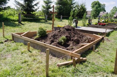 fresh grave soil and foundation in cemetery  clipart