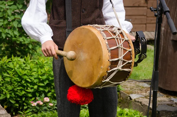 Drummer play folk music with drum and stick — Stock Photo, Image