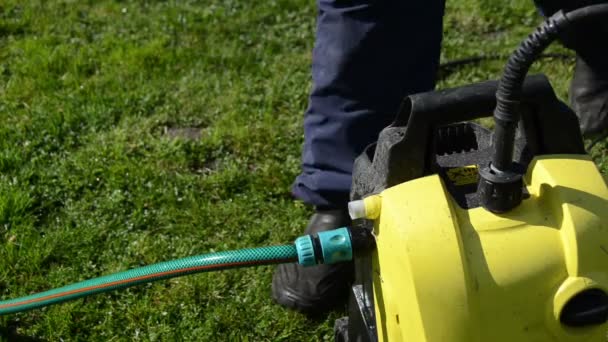 Man hand loskoppelen waterslang op hoge druk wassen apparatuur — Stockvideo