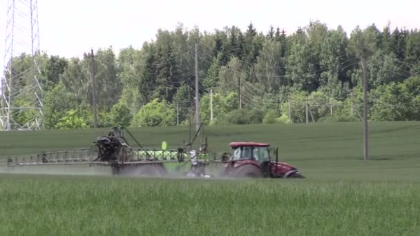 Tractor spray chemicals for crop plant protection from weed pest — Stock Video