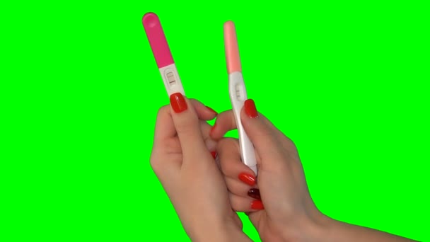 Woman girl holds two pregnancy tests with positive result two stripes — Stock Video