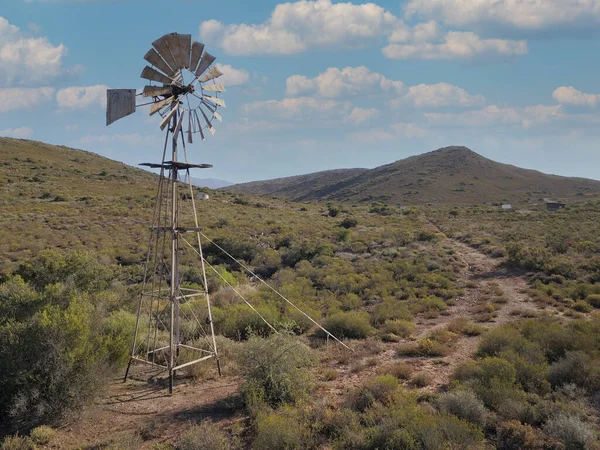 乾燥した風景の中に風車と水ポンプ — ストック写真
