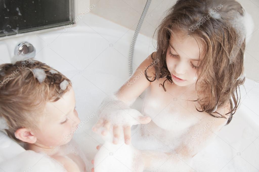 Brother and sister taking a bubble bath