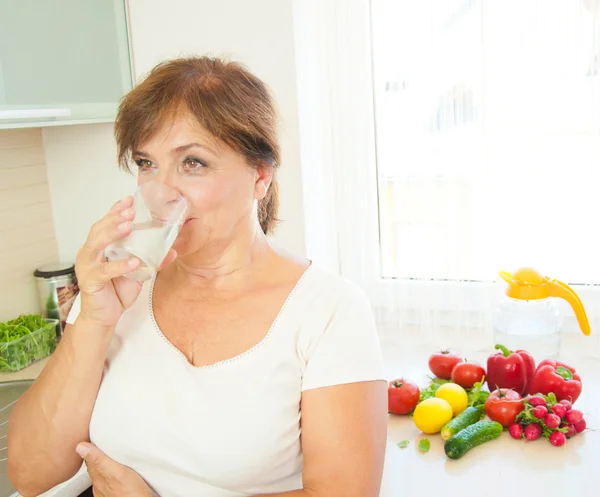 Old woman drinking water. — Stock Photo, Image