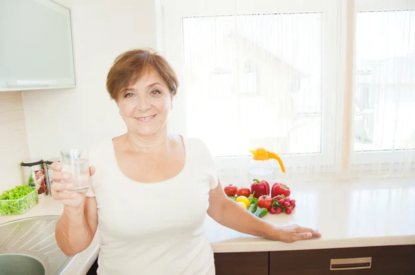 Old woman drinking water. — Stock Photo, Image