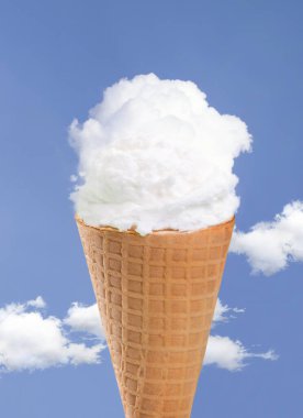 Refreshing ice cream cloud with crispy waffle cone on blue sky background