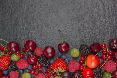 Bir kase rustik ahşap masa üzerinde çeşitli yaz taze çilek. Antioksidan, detoks diyet, organik meyve