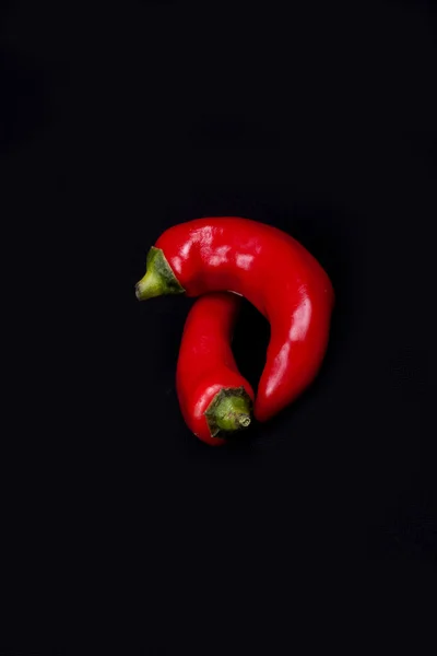 Rode chilipepers geïsoleerd op zwart. — Stockfoto