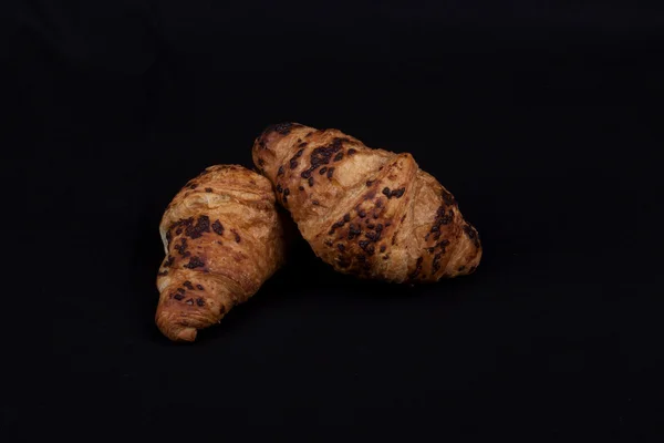 Fresh chocolate croissant on a black background — Stock Photo, Image