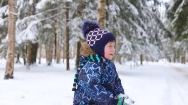 The boy throws snow and laughs . Happy childhood. Winter video picture. Snowy day