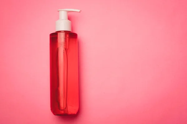 Botellas con gel para lavar sobre fondo rosa. Cuidado cosméticos. Copiar espacio. Artículo sobre la elección del gel para el lavado. — Foto de Stock