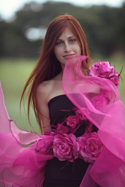 Roodharige meisje in de jurk van bloemen — Stockfoto