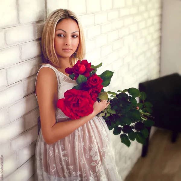 Pregnant woman with red roses — Stock Photo, Image