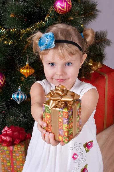 Happy smiling little girl with gifts — Stock Photo, Image