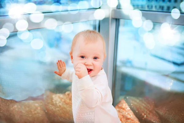 Blond baby girl years old in the interior in the evening — Stock Photo, Image