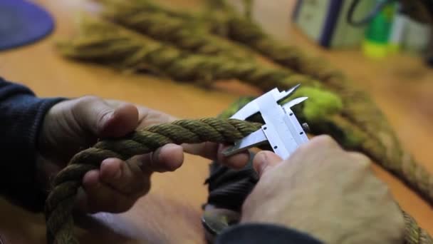 専門家の男性の手は キャリパーでロープを測定します 殺人兵器 — ストック動画