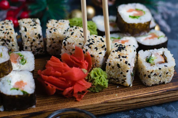 Ręcznie Trzyma Drewniane Kije Sushi Rolki Nasion Sezamu Ryb Nori — Zdjęcie stockowe