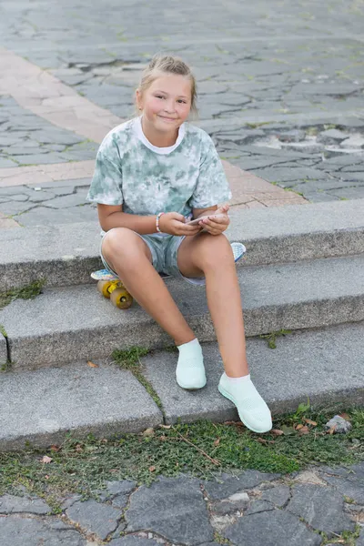 Happy Cute Teenage Girl Sits Skateboard Steps City Smartphone Her — Stock Photo, Image