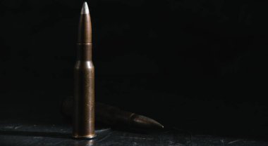 Cartridge on a dark background. The concept of modern armaments and wars.