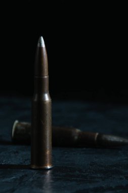 Cartridge on a dark background with space for text. Concept of Ukrainian-Russian.