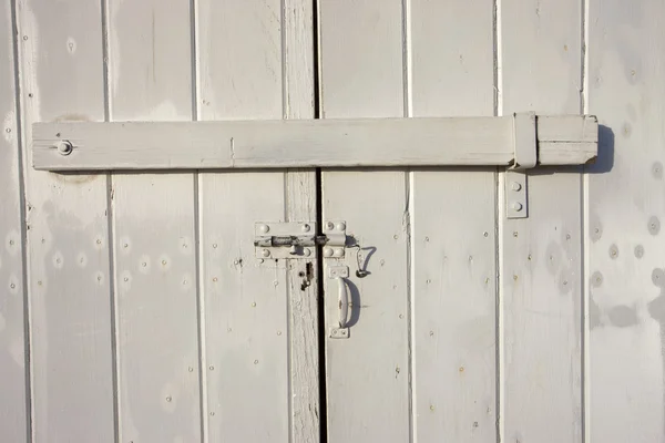 A latch that secures the door to an older building.