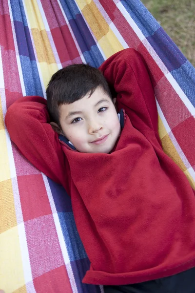 Boy lays down on hammock. — Stock Photo, Image