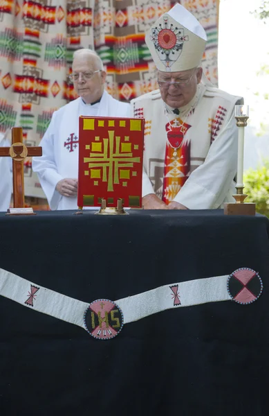 Jesuit priest at podium. — Stock Photo, Image