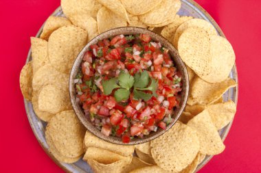 Closeup of salsa and chips. clipart