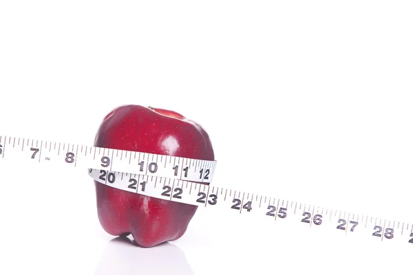 Red apple and tape measure. — Stock Photo, Image