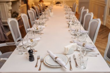 Tabaklı, şarap kadehli, çatallı, bıçaklı bir restoranın fotoğrafını çek.