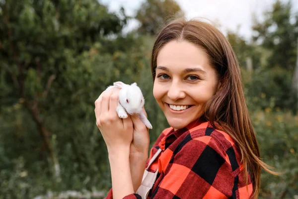 Young Happy Smiling Woman Farmer Holding White Baby Rabbit Her — 图库照片