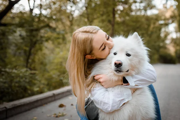 Young Beautiful Woman White Shirt Hugging Her White Dog Samoyed — стоковое фото