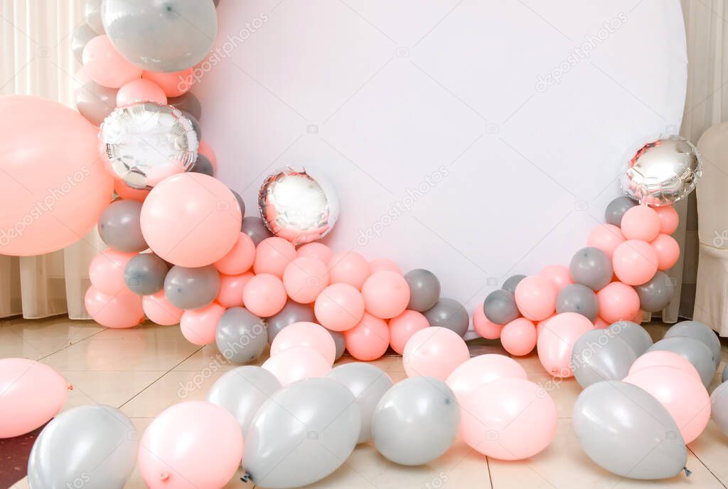 Close up the photo zone from pink and grey balloons with white copy space for your text. Party decorated with balloons